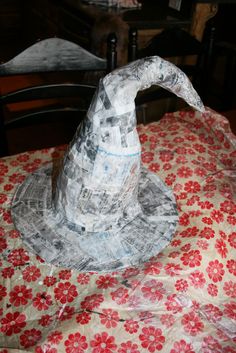 a paper wizard's hat sitting on top of a red and white table cloth