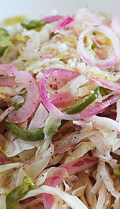 a white bowl filled with coleslaw and onions