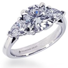 three stone diamond engagement ring in 18k white gold with pear shaped diamonds on the sides