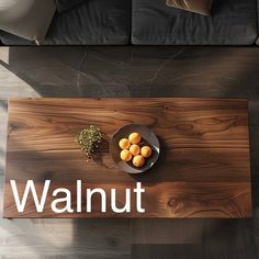 there is a sign that says walnut on the floor next to a bowl of fruit