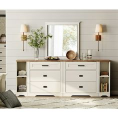 a white dresser with drawers and a mirror