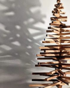 a sculpture made out of wooden planks in the shape of a christmas tree