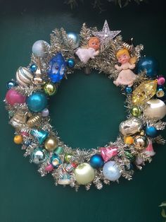 a christmas wreath with tinsel and ornaments