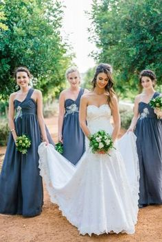 the bride and her bridesmaids pose for a photo