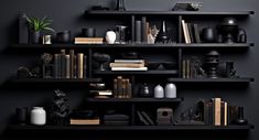 black shelves with books and vases on them