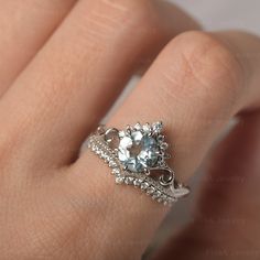 a woman's hand with a ring on it and a diamond in the middle