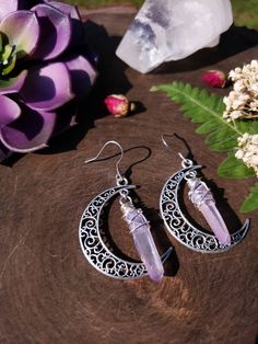 "Witchy moon earrings featuring a 40mm silver moon and wirewrapped lavender ab coated quartz crystals in the center. These are very lightweight and dainty. ➳ Total length is 2\" ➳ Silver ear wires are stainless steel and suitable for those with allergies. ➳ All components are tarnish resistant, lead & nickel free You may also like: https://www.etsy.com/listing/1033282062/quartz-earrings-moon-earrings-celestial https://www.etsy.com/listing/1033276034/boho-earrings-quartz-earrings-moon ̩̩͙✩*̩̩ Crystal Car Charms, Boho Mirror, Lavender Earrings, Lotus Earrings, Hippie Earrings, Silver Moon, Bohemian Earrings, Black Earrings, Moon Earrings