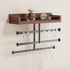 a wall mounted jewelry rack with several pairs of earrings hanging from it's sides