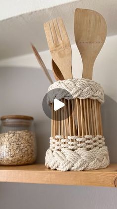 wooden utensils and spoons in a woven basket on a shelf next to jars