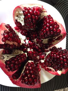 the pomegranate is cut in half on the plate