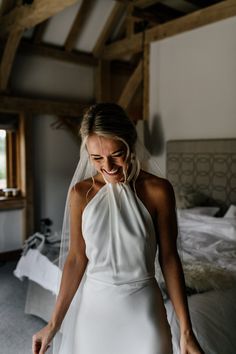 a woman in a white dress is smiling