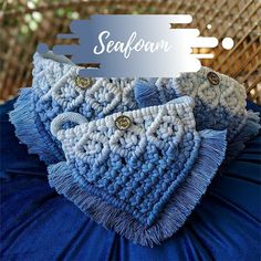 there is a blue and white crocheted blanket on top of a chair with the word seafoam above it