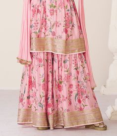 COLOR : Pink FABRIC : Top - Premium Organza Silk, Bottom - Premium Organza Silk, Inner - Santoon, Dupatta - Nazneen WORK : Zari Embroidery, Digital Print, Stones, Sequins, Lace Border OCCASION : Wedding, Reception, Engagement, Party Wear, Festival READY-TO-WEAR : No STITCHING : Available as semi-stitched fabric, can be stitched using standard size option (+$20). Note: There might be a slight color variation due to lighting and flash used during photoshoot. The bright shade seen is the best close Floral Print Semi-stitched Sharara For Reception, Pink Embroidered Palazzo Set For Reception, Pink Anarkali Palazzo Set With Floral Embroidery, Silk Floral Print Sets For Reception, Silk Sets With Floral Print For Reception, Pink Silk Sharara With Floral Embroidery, Bollywood Floral Print Sets With Traditional Drape, Bollywood Style Floral Print Sets With Traditional Drape, Pink Floral Print Palazzo Set For Wedding