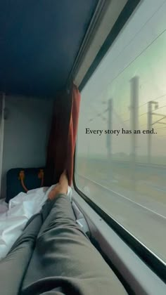 a person's feet are seen through the window of a train