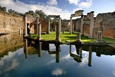 the ruins are reflected in the still water