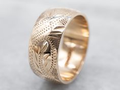 So many wonderful details come together to give this vintage band a rich, textural feel! Crafted of 14 karat yellow gold, this is a great band for stacking or wearing traditional as a wedding band!Metal: 14K Yellow GoldWidth of Band: 8.0 mmHeight off Finger: 1.4 mmRing Size: 6Marks: “<14K>” Stamped on the inside band Band Metal, Watch Chain, Botanical Pattern, Gold Hands, Vintage Band, Great Bands, Vintage Botanical, Come Together, Pearl Pendant