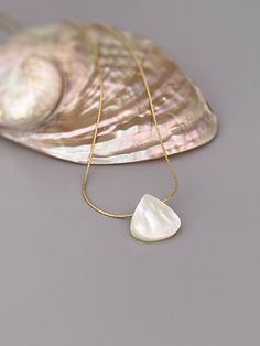 Handmade genuine mother of pearl necklace. A dainty solitaire necklace for women with an iridescent mother of pearl shell on your choice of a delicate sterling silver or 14k gold filled  chain. Perfect summer or beach wedding necklace. A simple, elegant pendant necklace perfect for everyday wear.  Beachy summer jewelry Mother of Pearl size: 14mm tall x 14mm wide (approx 1/2") PLEASE note measurements and size reference pictures. Our jewelry and hair accessories are photographed close up to show White Shell-shaped Jewelry With Pearl Pendant, Pearl White Mother Of Pearl Shell Necklace As Gift, Pearl White Mother Of Pearl Shell Necklace Gift, Pearl White Shell Jewelry Gift, Elegant Shell Jewelry For Anniversary, Elegant Mother Of Pearl Shell Pendant Necklace, Adjustable Shell-shaped Pearl White Jewelry, Shell-shaped Pearl Pendant Jewelry Gift, Shell-shaped Pearl Pendant Jewelry For Gift