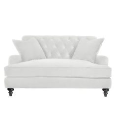 a white couch with two pillows on it