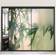 an image of the inside of a room with glass doors that look like bamboo leaves