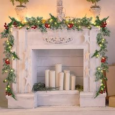 a fireplace decorated with candles and greenery