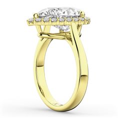 a yellow gold engagement ring with three stones on the band and an oval center stone