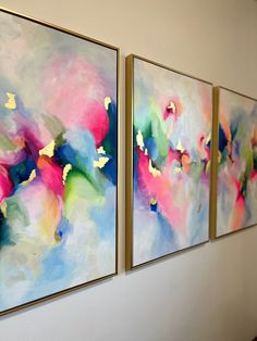 three paintings hanging on the wall next to each other