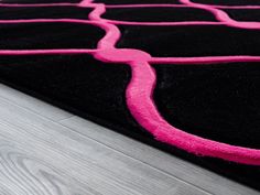 a black and pink rug on the floor