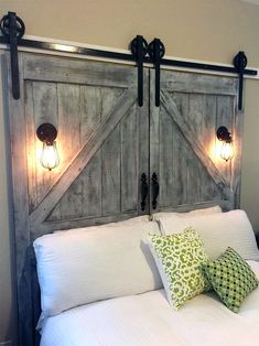 a bed with two headboards made out of wood and some lights on each side