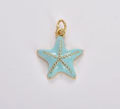 a starfish charm is shown on a white surface with gold dots around the edge