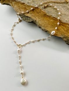 Classic and dainty freshwater and gold Lariat necklace. - 4mm Rice freshwater Pearl beads. - 10mm Coin Freshwater Pearl bead. - 14k Gold filled closure. Adjustable 2 inches extender chain. * Custom orders welcome. Freshwater pearls are cultured pearls, grown in lakes, rivers, as well as ponds. Most Freshwater pearls are white and resemble Akoya pearls, but they also produce a variety of pastel shades, including pink, lilac and peach. Every once in awhile, you see things that bring you pure joy. Gold Earring With Pearl, Pearl Drop Lariat Necklace As Gift, Pearl Drop Lariat Necklace Gift, Dainty Pearl Lariat Necklace As A Gift, Dainty Long Drop Pearl Drop Necklace, Dainty Long Drop Pearl Necklaces, Gold Adjustable Backdrop Necklace With Pearl Drop, Pearl Drop Lariat Necklace, Pearl Lariat Necklace With Pearl Chain