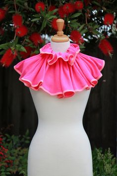 a white mannequin with pink ruffles on it