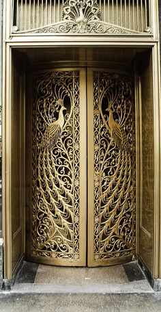 an intricately carved wooden door on the side of a building