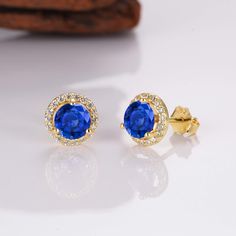 Add a little luxury, class, and sophistication to your look with our breathtaking Jia sapphire earrings. Made from our stunning gold on sterling silver materials, each iconic earring features a whopping 0.75-carat center sapphire. We’ve also added numerous stunning CZ crystals around the outer rim of the earrings for an unrivaled shine. ✦ DETAILS ✦ ✧ Handcrafted ✧ .75 Carat center stone ✧ Sapphire and cz crystals ✧ 8mm (about 6/8 inch round) ✧ Sterling Silver 925 or 14K Rose Gold Vermeil or 14K Alexandrite Necklace, Pave Heart Necklace, Rutilated Quartz Necklace, Black Gold Ring, Sterling Silver Rings Set, Earrings Rose Gold, Silver Ring Set, Solid Gold Necklace, Gold Ring Sets