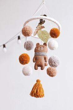 a teddy bear mobile hanging from a ceiling