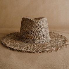 Discover the Acapulco hat: a new frayed straw hat handmade in México from seagrass. Shine at your holiday destination with this light and airy hat. The frayed edge and diamond shape of the crown give it a boho-chic touch. The elastic band on the inside provides strength and wearing comfort. Handcrafted in Mexico Ethically made from natural material Support artisanal communities Brand Partnership with Sandoval. Summer Hats With Open Weave And Flat Brim, Summer Flat Brim Open Weave Hat, Summer Open Weave Hat With Flat Brim, Flat Brim Open Weave Straw Hat For Beach, Open Weave Flat Brim Straw Hat For Beach, Beach Straw Hat With Flat Brim And Open Weave, Beach Straw Hat With Short Brim And Open Weave, Bohemian Wide Brim Straw Hat With Open Weave, Summer Hat With Open Weave And Curved Brim