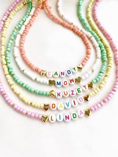 "Welcome to our vibrant and joyful personalized name necklace collection! Our colorful necklaces are perfect for children and make for a wonderful kids' birthday gift, designed to bring smiles to their faces. With six stunning color options to choose from, each necklace is a unique masterpiece. Crafted with colorful beads and adorned with Mother of Pearl letters that spell out a custom name, these necklaces are truly one of a kind. Make your little one's day special by gifting them a personalized name necklace that reflects their unique personality and style. Whether it's for a birthday, a special occasion, or just to show your love, these necklaces are sure to be cherished keepsakes.\" HOW TO ORDER ? 1- Choose the letter quantity of the name/word/phrase/initials you want. 2- Find the righ Cute Multicolor Customized Jewelry, Cute Personalized Multicolor Charm Necklaces, Customized Cute Multicolor Jewelry, Trendy Personalized Necklace For Birthday, Trendy Personalized Jewelry For Birthday, Customized Multicolor Cute Jewelry, Trendy Customizable Necklaces For Personalized Gifts, Trendy Customizable Necklace For Personalized Gifts, Customizable Pink Nameplate Jewelry