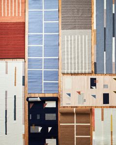 many different colored rugs are laid out on the floor and one is folded up