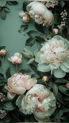 an image of flowers that are in the middle of some leaves and flowers on a green background