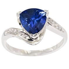 a white gold ring with a blue sapphire and diamonds on the band, set in 18k white gold