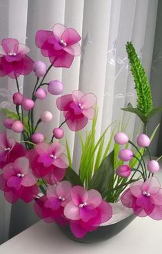 a vase filled with pink flowers on top of a table