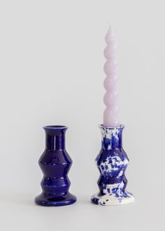 two blue and white vases sitting next to each other