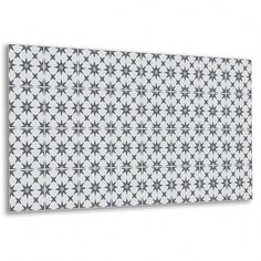 a white and black wall with an intricate design on the top, in front of a white background