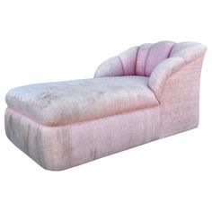 a pink chaise lounger sitting on top of a white floor