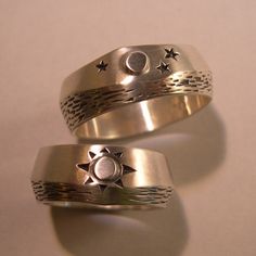 "There is nothing like seeing the moon's glint off water on a peaceful night, and in the morning...the sun is shining. Like Yin and Yang, night and day work together in a circle of life. What wonderful symbols for wedding bands! These rings have a soft brush finish, but could also be done in high polish. I have used oxidation, or antiquing to bring out the details. The width varies slightly in the design of both rings, which gives a truely custom feel. Both rings measure in width about 5/16\" wi Elegant Sun And Moon Design Rings For Anniversary, Elegant Sun And Moon Design Anniversary Rings, Celestial Style Engraved Wedding Jewelry, Celestial Style Engraved Jewelry For Wedding, Mystical Engraved Wedding Jewelry, Celestial Sun And Moon Design Rings For Anniversary, Celestial Rings With Sun And Moon Design For Anniversary, Celestial Jewelry With Sun And Moon Design For Promise, Engraved Moon Shaped Jewelry For Wedding