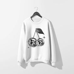 Get groovy in our Disco Cherries White Sweatshirt. Featuring sparkly Y2K vibes, this trendy sweatshirt will elevate your style game. Perfect for adding a touch of whimsy to your everyday look. (Disco ball not included!). This sweatshirt features a bound ribbed neckband, ribbed sleeve cuffs and hemband, and raglan sleev Trendy Fall Graphic Sweatshirt, Trendy Long Sleeve Sweatshirt With Funny Print, Trendy Fall Sweater With Screen Print, Trendy Crew Neck Sweater With Screen Print, Trendy Fall Sweatshirt With Screen Print, Trendy Graphic Print Sweatshirt For Fall, Trendy Winter Graphic Sweatshirt, Trendy Relaxed Fit Sweatshirt With Screen Print, Trendy Streetwear Sweater With Screen Print