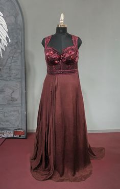 Look simply stunning in this designer Maroon Color Chiffon gown. It is embellished with stone, and Cutdana work all over. Highlight of the gown is the Beautiful Embroidered Neck Design. Slight variation in color, fabric & work is possible. Pictures shown are for illustration purpose only. NOTE: Originally stitched in size 42 but can be altered for size 40 without any extra cost. Style: Gown Fabric: Chiffon, Net Work: Stonework, Sequins Work, Cutdana Colour: Maroon Length: 62 Chest: 42 Waist: 32 Cutdana Work, Western Gown, Sequence Blouse, Indo Western Gown, Saree Petticoat, Full Sleeve Blouse, Fabric Work, Saree Jewellery, Lehenga Skirt