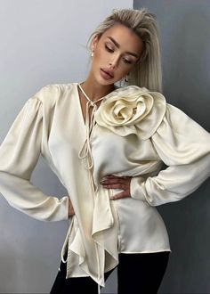 This 3D flower decor blouse features a flattering v-neck design and loose, comfortable fit. Made from luxurious satin fabric, it drapes beautifully and is available in a versatile beige color. With long sleeves, it is perfect for any occasion. Fabric: Non-Stretch Material: Polyester, Cotton Elegant Beige Blouse For Spring, Beige Satin Tops For Spring, Beige V-neck Blouse For Party, Luxury Satin Blouse, Cream V-neck Blouse For Party, Chic Cream Satin Top, Luxury Satin Blouse With Buttons, Cream V-neck Party Blouse, Elegant Cream Satin Top