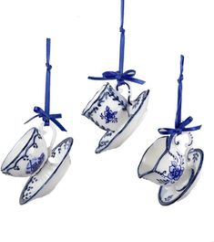 three tea cups hanging from strings with blue bows