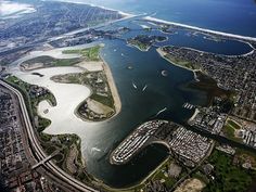 an aerial view of a city and water from the air, with lots of land around it