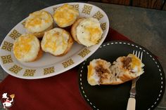 a plate with some food on it next to a fork and cupcakes that have been cut in half